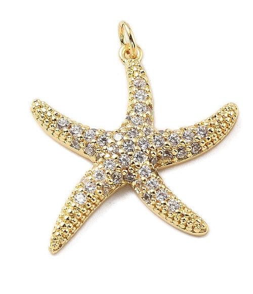Gold starfish charm paved with clear cubic zirconia stones and finished with a top jump ring.