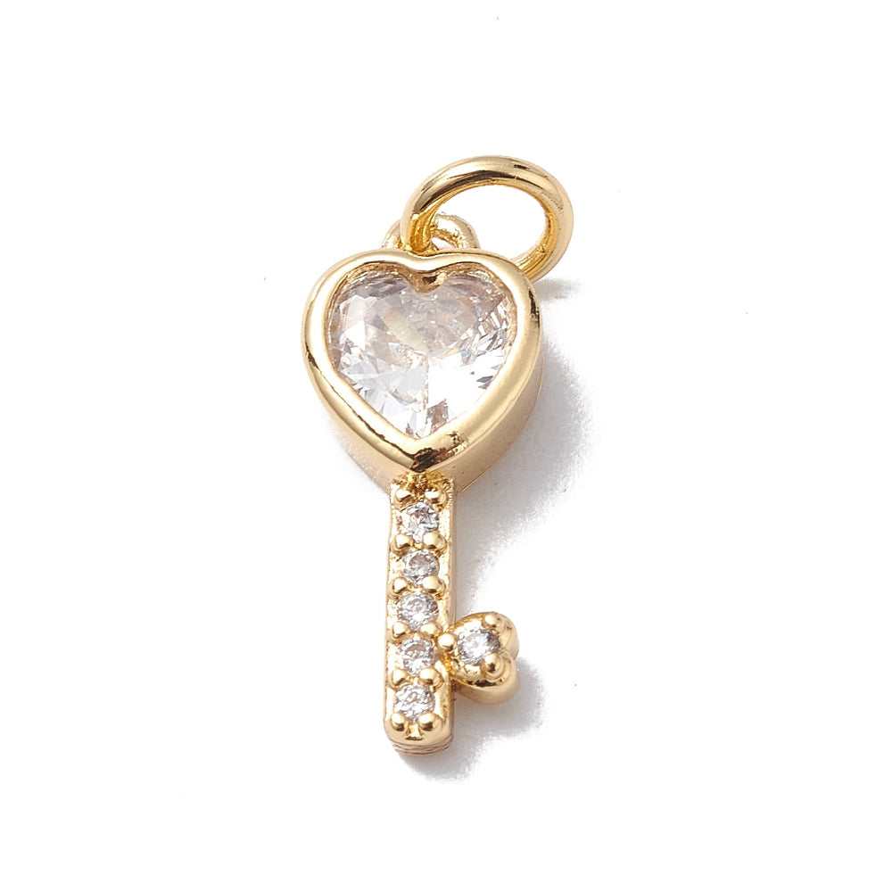 Gold-tone charm in a heart key design featuring a faceted clear heart stone and small pave-set crystals.