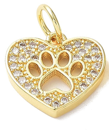 Gold-tone charm featuring a heart shape with a cutout gold paw print in the center, paved with clear stones.