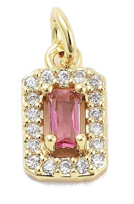 Rectangular gold-tone charm featuring a faceted pink stone surrounded by a halo of small clear crystals.