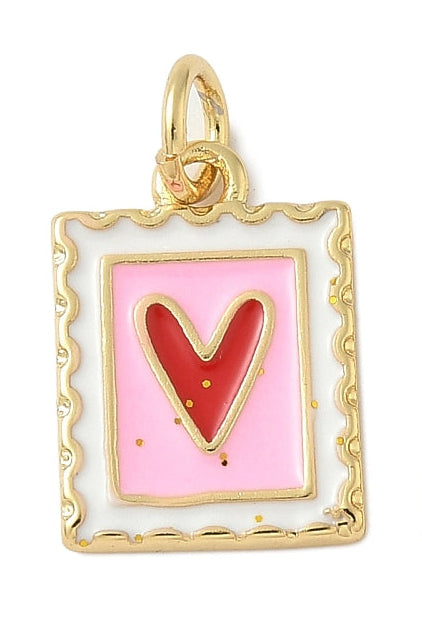 Gold-tone heart stamp charm with scalloped edges, featuring a red enamel heart on a pink and white background.