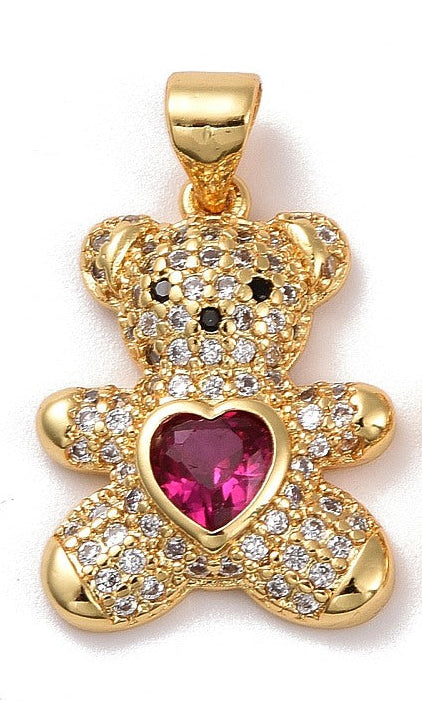 Gold-tone charm shaped like a teddy bear, embellished with clear pavé stones and a pink heart-shaped center stone.