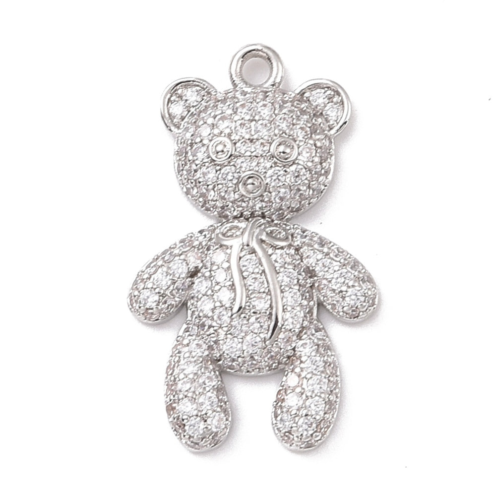 Silver teddy bear charm paved with clear rhinestones, featuring a small smooth silver bow around its neck and a top loop.
