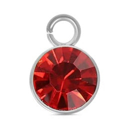A round, faceted red July birthstone charm in a silver-tone bezel setting with a top jump ring.