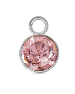 A silver October birthstone charm featuring a round, faceted pink stone in a silver-tone bezel setting with a jump ring.