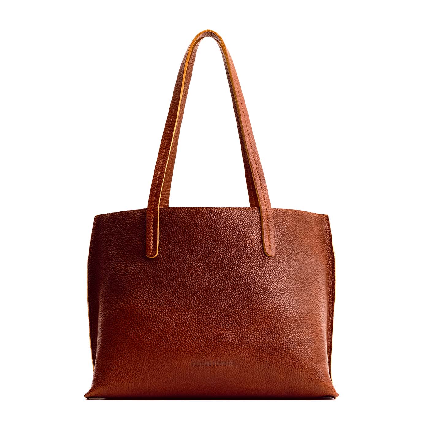 Nutmeg brown pebbled leather August Tote featuring two shoulder straps and a structured, open-top design.