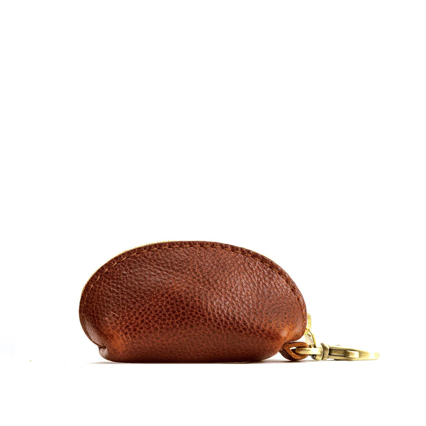 Nutmeg brown textured leather taco keychain with a half-moon shape, zipper closure, and brass-tone clasp.