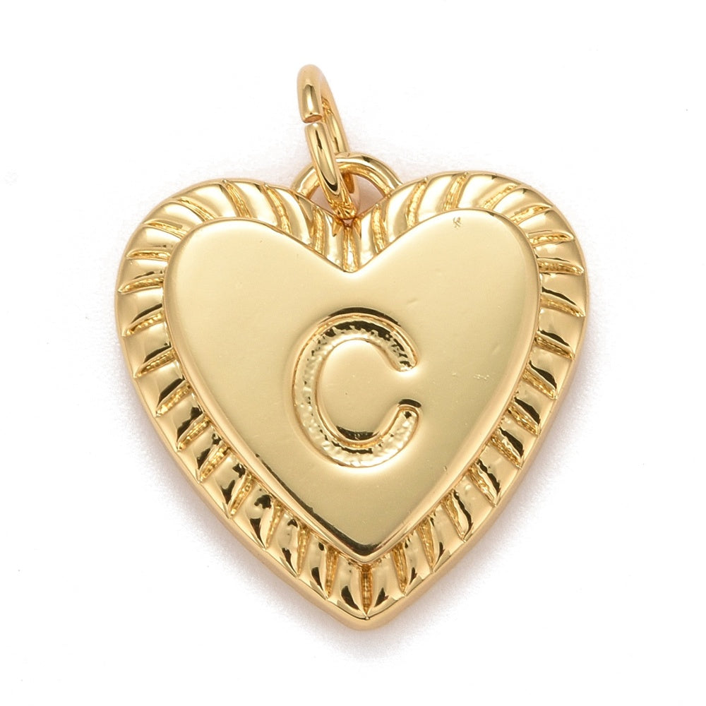 Gold-tone heart-shaped initial charm featuring an embossed letter C, a smooth center, and a textured fluted border.
