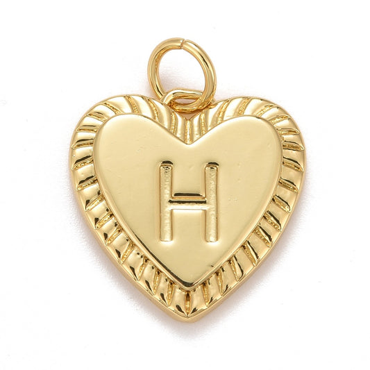 Gold-tone charm in a heart shape featuring a textured, ridged border and an embossed letter H.