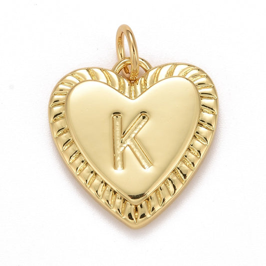 Gold-tone heart-shaped initial charm featuring an embossed letter K inside a smooth heart with a ribbed border.
