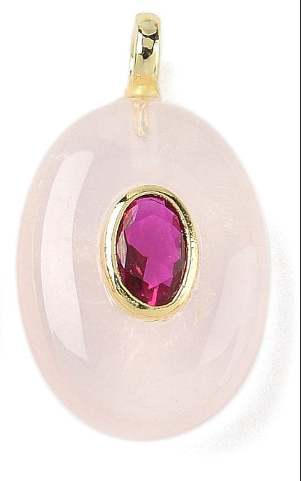 Oval rose quartz bezel charm featuring a smooth, pale pink stone with a faceted magenta center stone in a gold-tone setting.