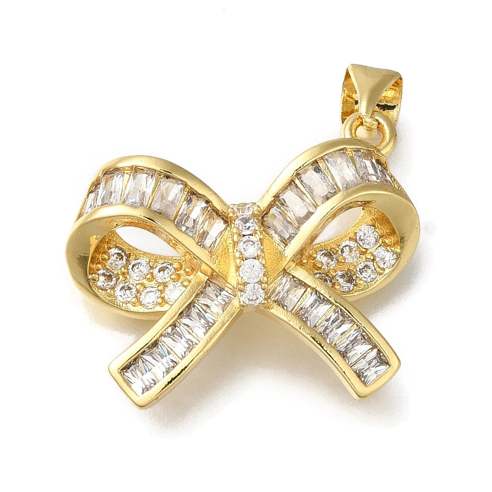Gold bow charm embellished with clear baguette and round stones, featuring a top bail for attachment.