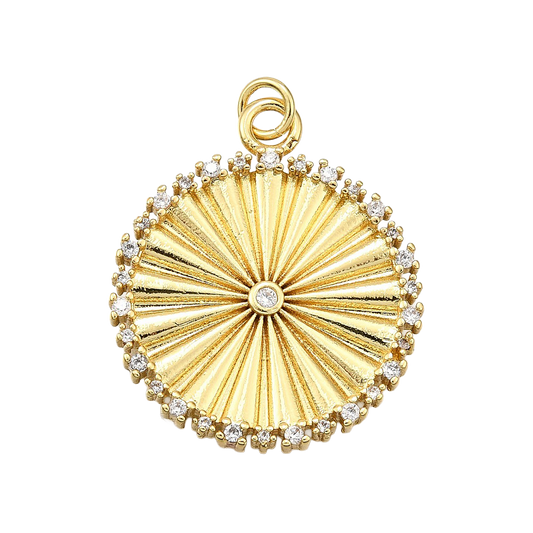 Gold circle pendant featuring a radiating sunburst texture, a central clear stone, and a crystal-studded border.