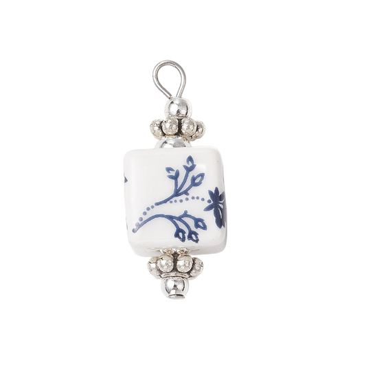 Silver-tone and blue porcelain charm featuring a square white bead with blue floral details and a top loop.