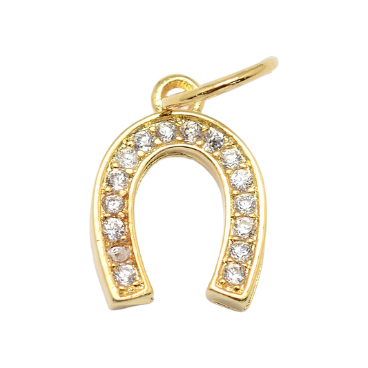 Gold horseshoe charm embellished with clear stones, featuring a top jump ring for a charm necklace or bracelet.