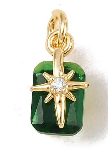 Emerald Star gold-tone charm featuring a rectangular faceted green stone with a central gold starburst and clear gem.