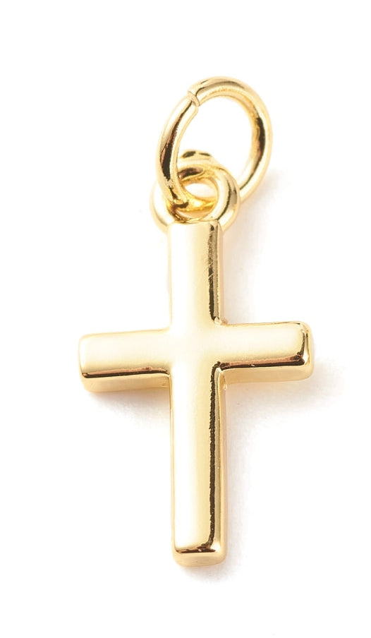 Gold cross charm with a smooth, polished finish and a jump ring for attaching to jewelry.