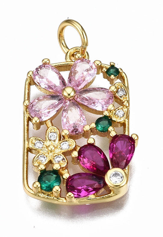 Rectangular gold-tone charm featuring an openwork floral design with pink, magenta, and green crystal stones.