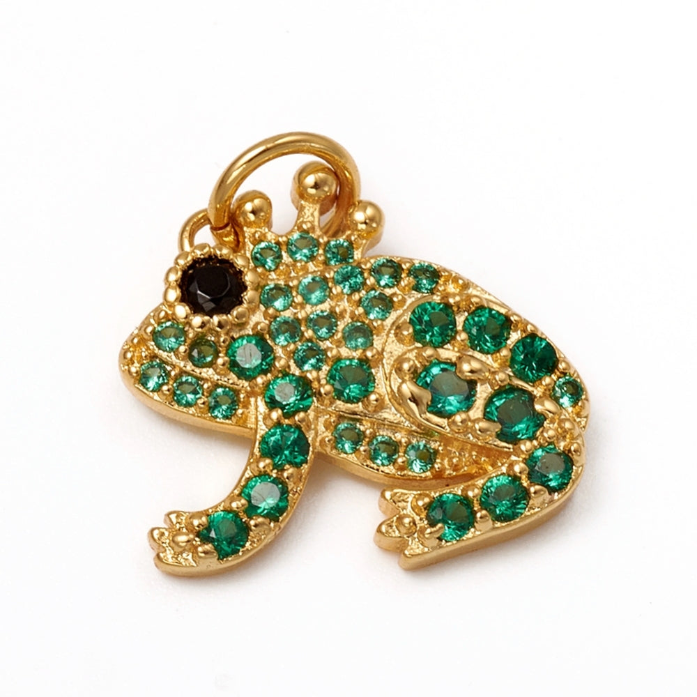 Gold frog charm detailed with green gemstones, a black crystal eye, and a gold-tone crown at the top.