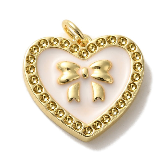 Heart bow gold-tone charm featuring a light pink enamel background, raised gold bow, and a dotted border.