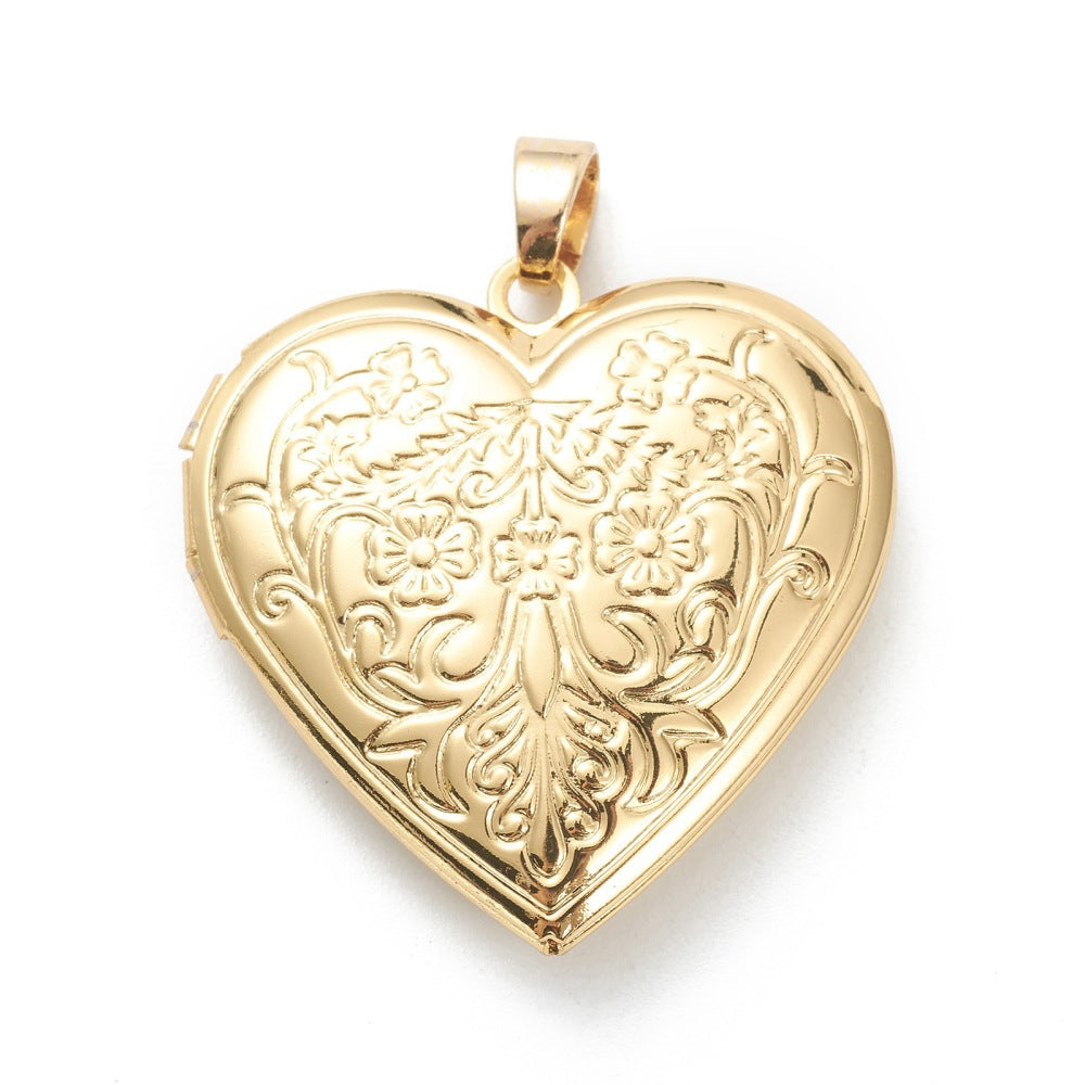 Gold heart locket with an intricate, vintage-style floral and scrollwork engraving on a polished gold-tone surface.
