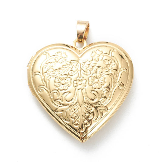 Gold heart locket with an intricate, vintage-style floral and scrollwork engraving on a polished gold-tone surface.