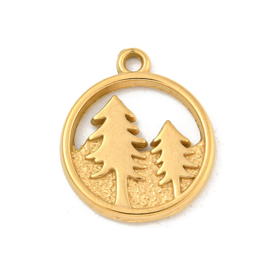 Circular gold-tone charm featuring a cutout design of two evergreen trees on a textured ground.