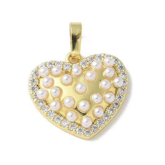 Gold pearl heart charm featuring a border of clear stones and a center filled with miniature white pearls.