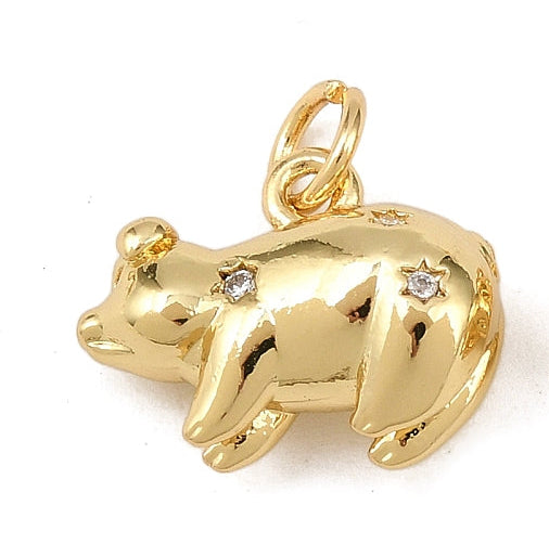 Gold-tone piggy charm with a polished finish, starburst engravings featuring clear stones, and a top jump ring.