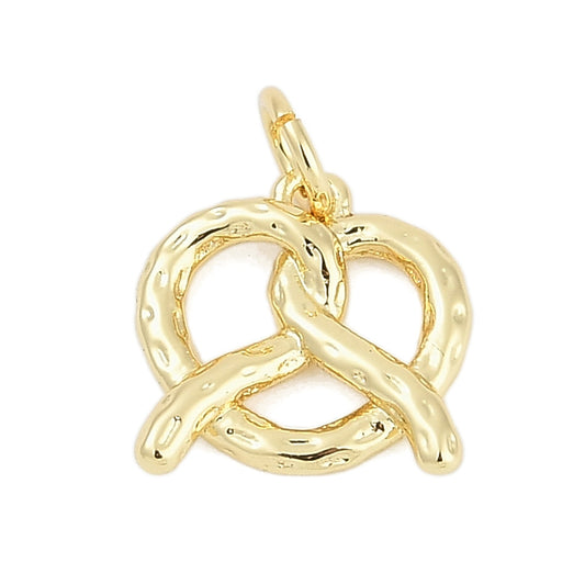 A gold pretzel charm featuring a textured, dimpled surface and a top loop for attachment.