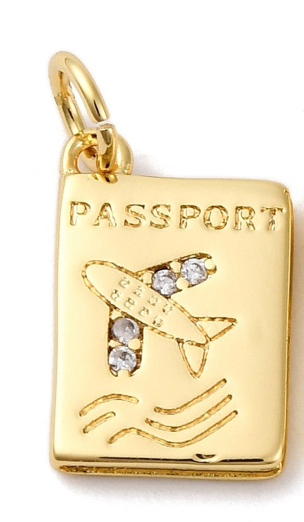 Gold-tone passport charm featuring an engraved airplane set with clear stones and the word PASSPORT at the top.