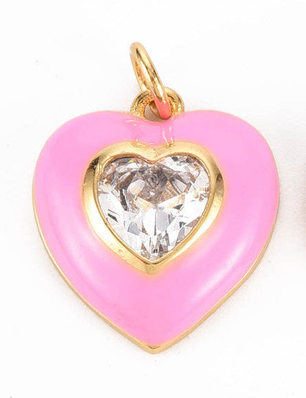 Pink bezel heart charm featuring a clear heart-shaped crystal stone in a gold-tone setting with pink enamel.