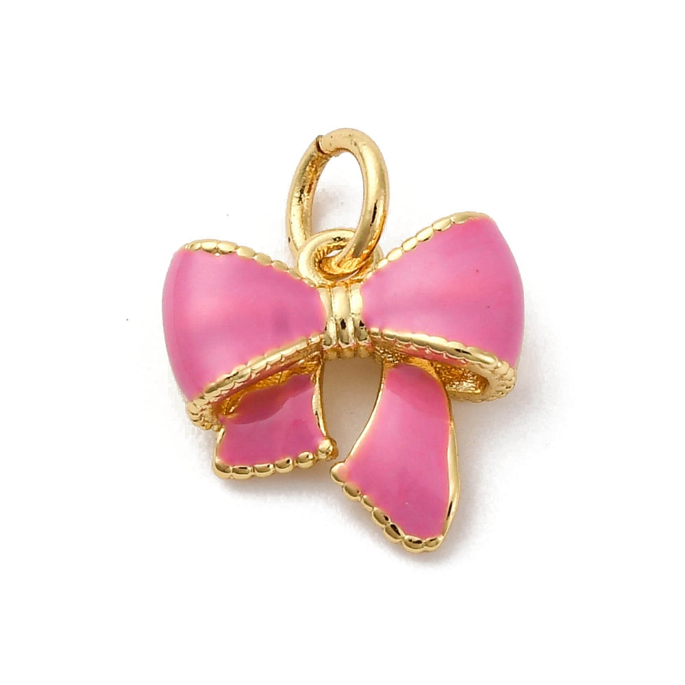Pink bow gold-tone charm featuring pink enamel filling and a beaded gold-tone border with an attached top jump ring.
