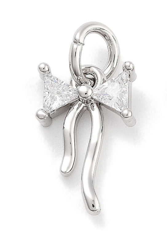 CZ silver bow charm featuring two clear, triangular cubic zirconia stones and curved silver-tone ribbon tails.
