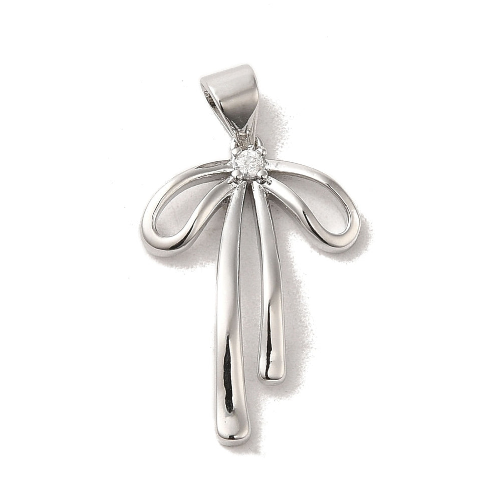 Silver bow pendant charm featuring a clear stone at the center knot with a bail for a necklace chain.